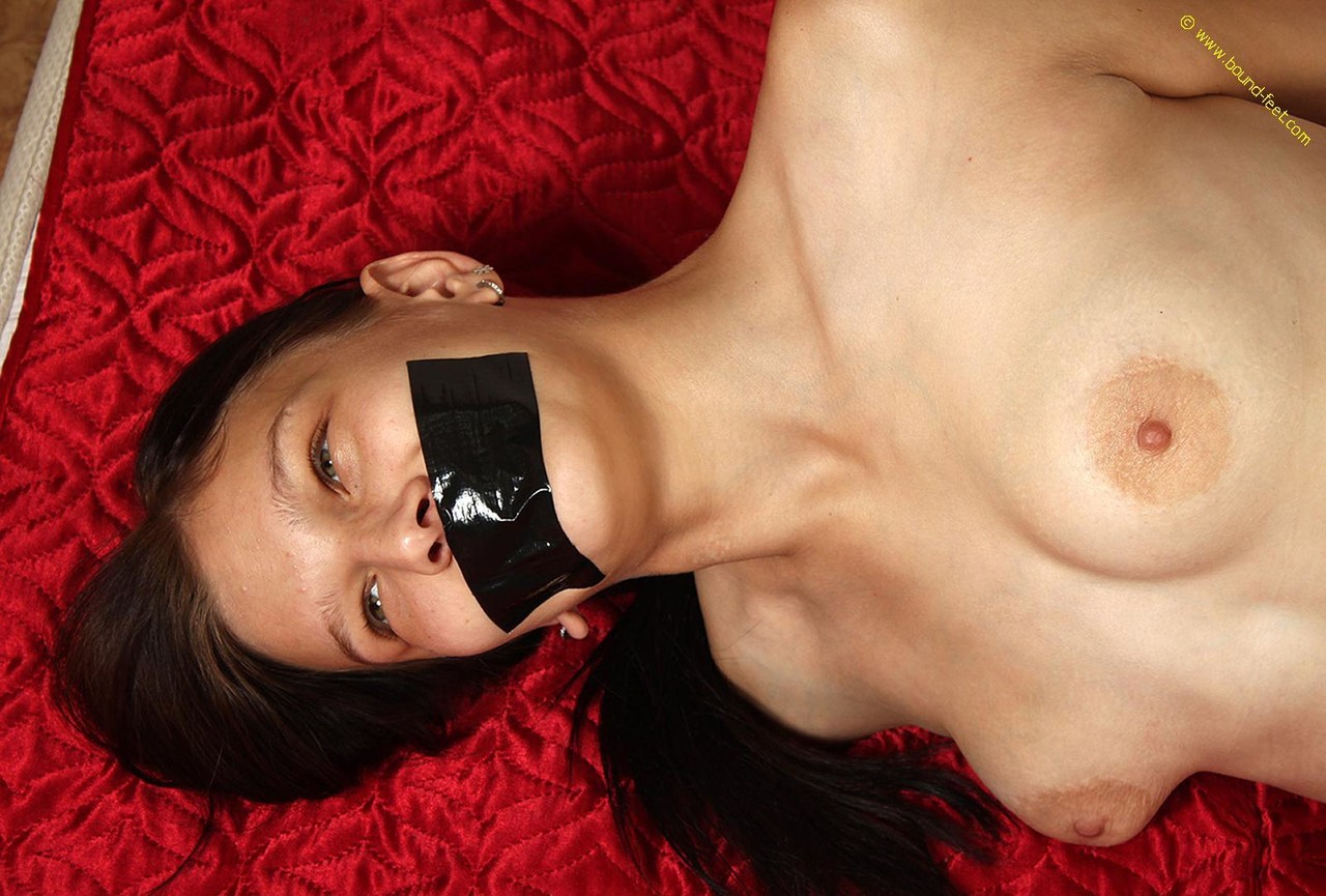 Caucasian Girl Is Hogtied And Silenced With Duct Tape While Topless In