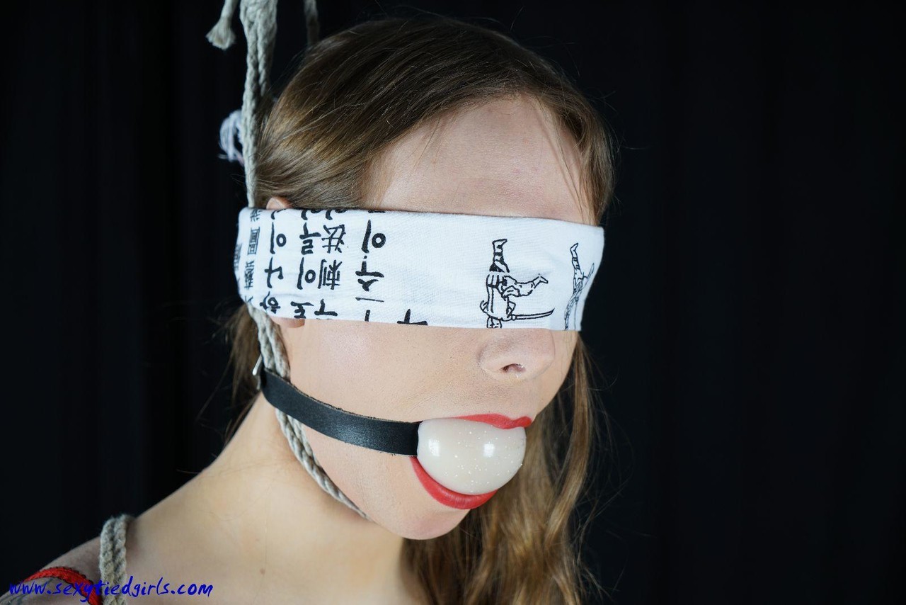 White girl sports a ball gag a noose before being blindfolded in bondage -  NakedPics