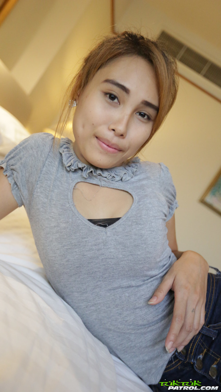 Young Thai girl in braces bares her small tits and neatly trimmed twat on  bed - NakedPics