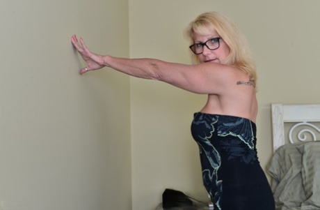 Canadian housewife in glasses strips down to stockings and heels on her bed