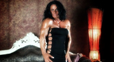 Dark-haired bodybuilder Debbie Bramwell flexes her muscles during SFW action