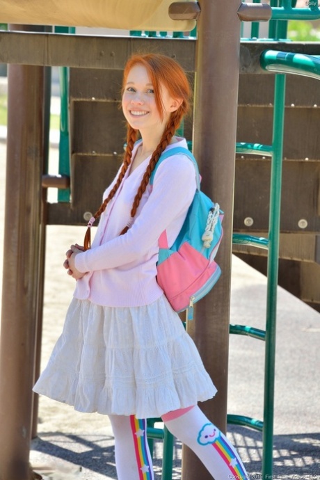 Young redhead in pigtails flashes pussy at the playground & toys in socks