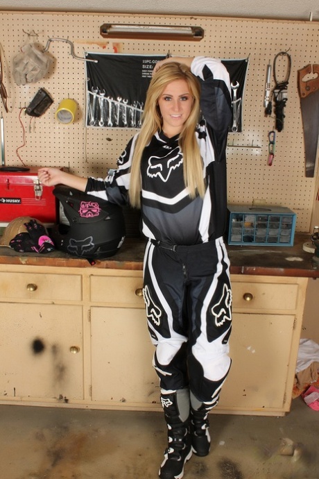 Amateur race driver Ashley Vallone strips her gear to tease in the garage