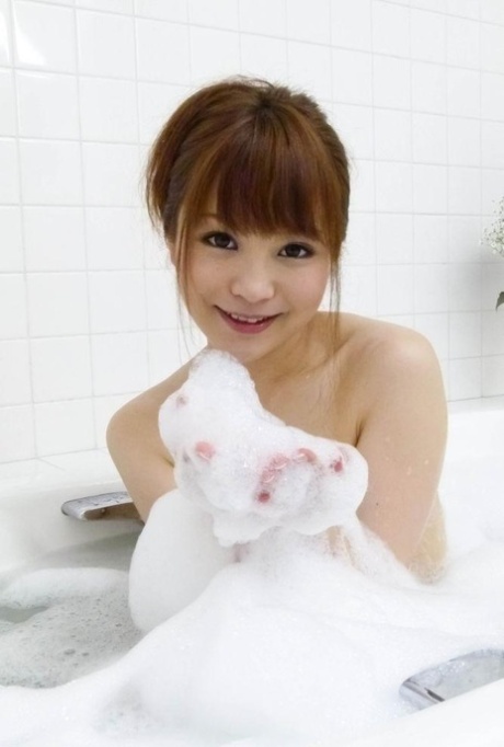 Japanese cutie Maomi Nagasawa sucks off two cocks while taking a bubble bath