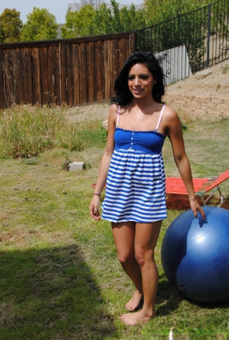 Schattige brunette Kelly Xoxo gaat helemaal naakt op een medicijnbal in een tuin.
