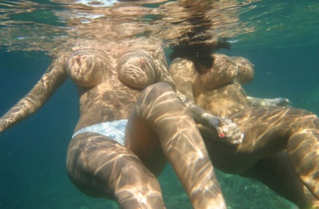 Busty Polish women Aneta Buena & Kora Kryk swim topless underwater