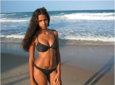 Brazilian amateur Polliana models a bikini on a sandy beach