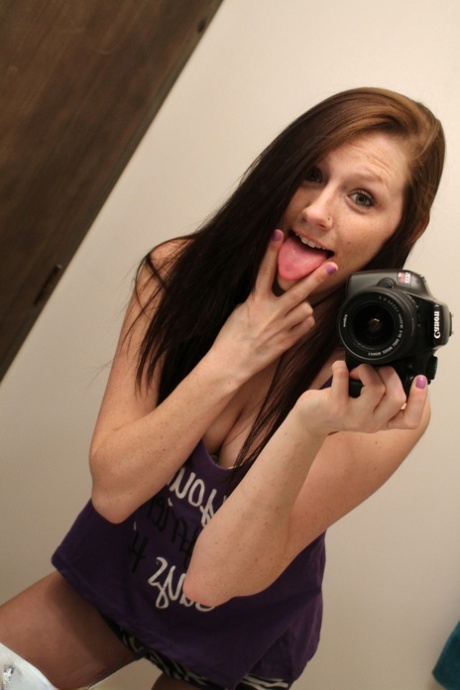 Amateur chick Freckles 18 sticks out her tongue while taking mirror selfies