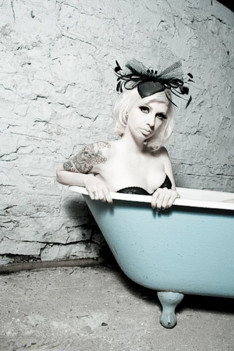 Tattooed chick Lynn Pops goes topless in a clawfoot bathtub