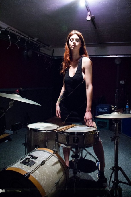 Sexy redhead Azura Starr gets naked while sitting at her drum kit