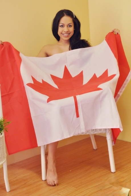 Cute Canadian teen Cindy Cupcakes holds a flag before showing her naked body