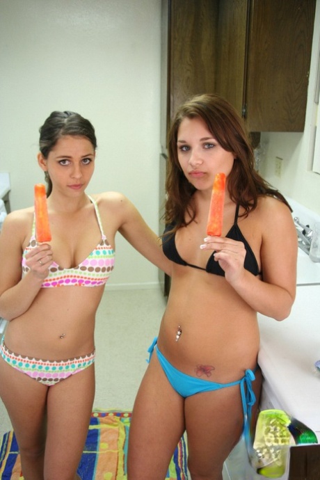 Teen lesbians Lili Jensen & Cali Logan lick frozen treats and nipples