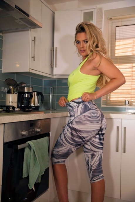 Big titted hottie Danielle Sellers flaunting her sexy round ass in the kitchen