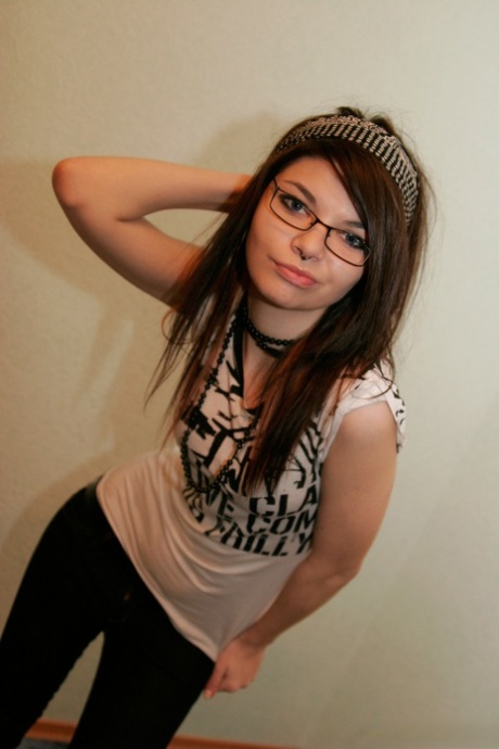 La giovane bruna Kaira 18 si toglie gli occhiali mentre fa la modella non nuda
