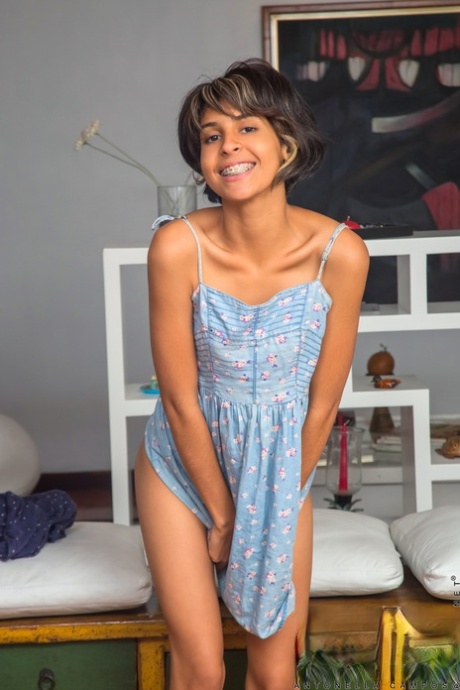 Latina teen Antonella Campos sports short hair while posing nude on a dresser