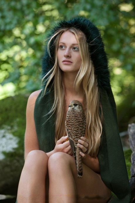 Sexy Blondine mit schönen Titten und Arsch geht nackt mit ihrem Hawk auf die Jagd