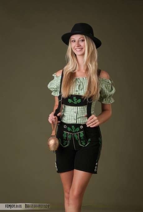Busty blonde Carisha takes off Bavarian themed clothing to model in the nude