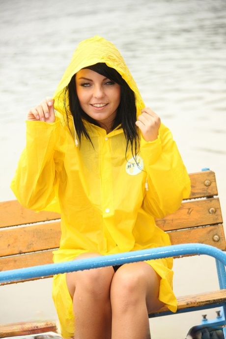 Dark haired teen shows her tits and twat outdoors in the rain