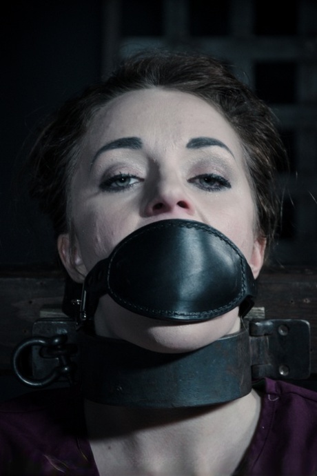 Female sex slave Kate Kenzi is restrained in numerous ways in a dungeon