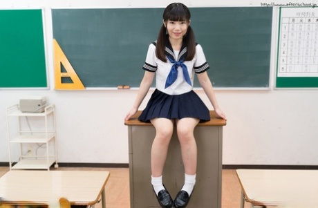 Tiny titted Japanese schoolgirl undressing to stand naked in the classroom