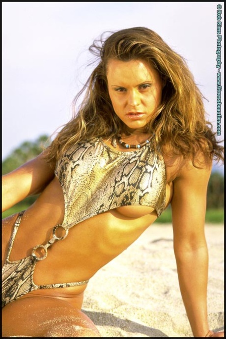 Bodybuilder Timea Majorova strikes great poses at the ocean in swimwear