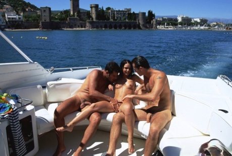 Dark haired girl does anal while fucking two guys on a boat