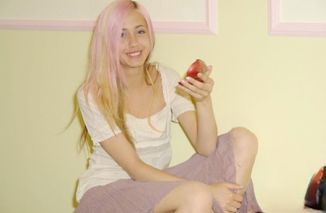 Beautiful teen does her makeup while holding a compact mirror