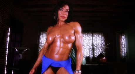 Latina bodybuilder Marina Lopez sports an oily shine while topless and flexing