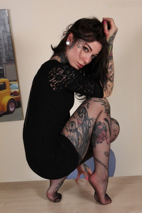 Hot tattooed secretary doffs her glasses & models sexy legs in black pantyhose