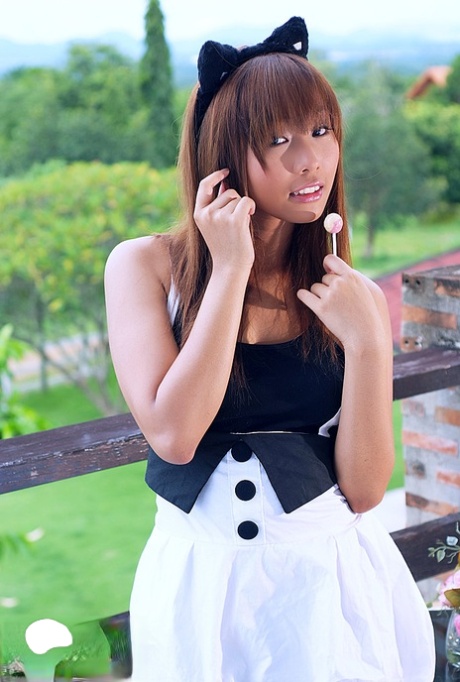 Cute Thai redhead Nana Sarin gets naked while wearing cat ears