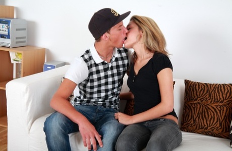 Blonde teen makes out with her boyfriend before they have sex on a sofa