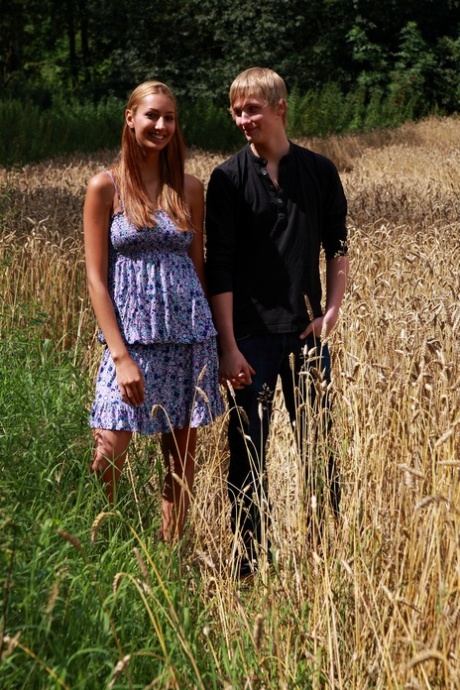 Redheaded teen and her boyfriend have sex in a field of mature wheat