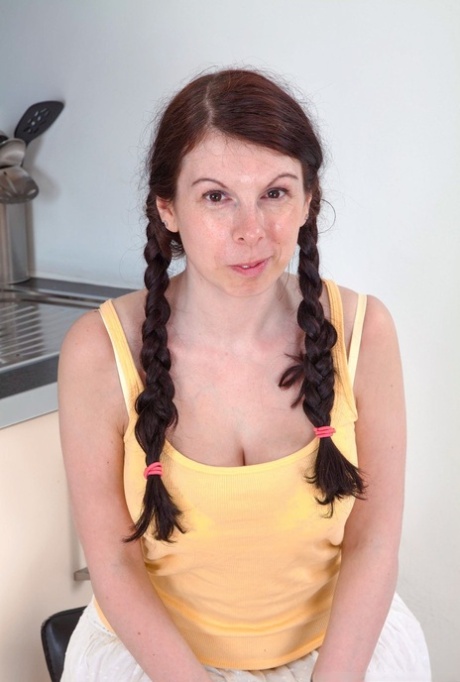 Brunette amateur Emily Winters shows off her really hairy pussy in pigtails