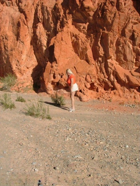 Mature blonde plumper Adonna sets her huge boobs loose in desert
