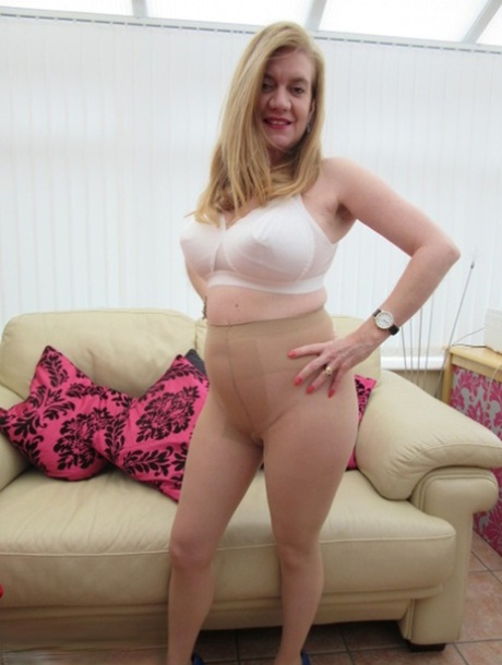 Plump mature Lily May flaunts her floppy tits & big ass in tan pantyhose