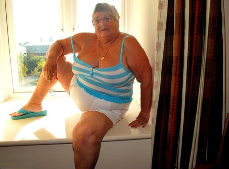 UK amateur Grandma Libby creams her pussy after getting naked in a windowsill