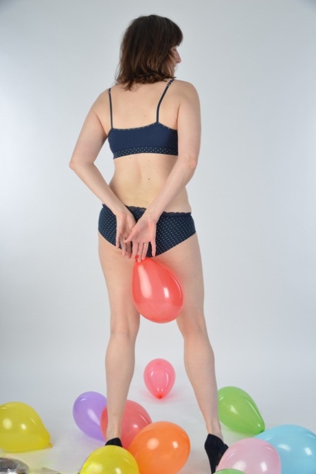 Amateur woman Hot MILF uncovers her breasts after holding balloons