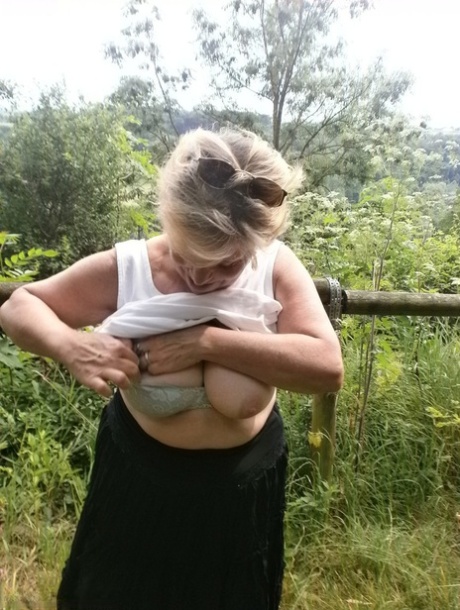 Mature amateur whore Caro masturbating on the bench in the woods