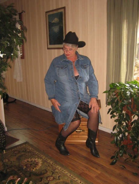 Fat oma Girdle Goddess strips naked in a cowgirl hat and boots