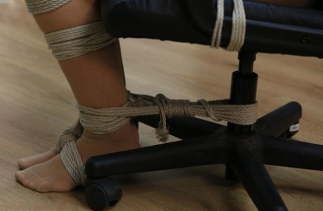 Caucasian chick sports a gag while tied to a computer chair