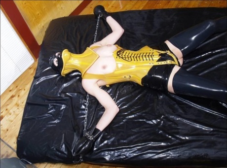 Dark-haired girl is restrained and masturbated in latex before posing alone