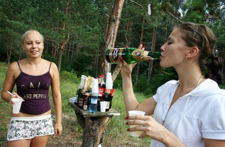 College kids gets drunk at a campsite in the woods before having an orgy