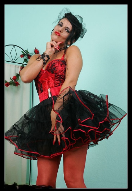 MILF morena mostra as mamas e a rata enquanto usa uma saia de showgirl vintage