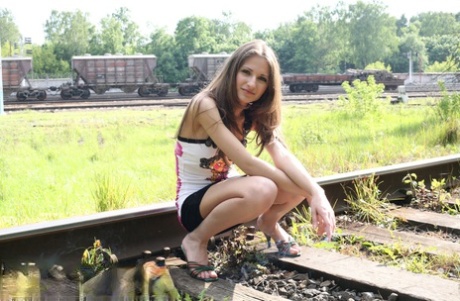 Young amateur Sveta displays her pussy on railway tracks with no panties on