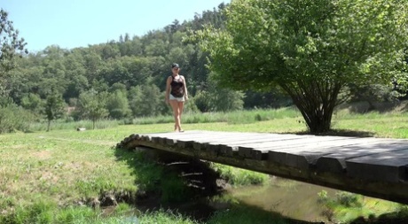 Barefoot chick Licky Lex takes off her shorts before pissing off of a bridge