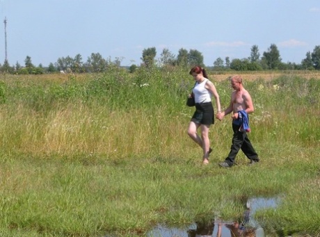 Redheaded plumper has sex in a field with a homeless man