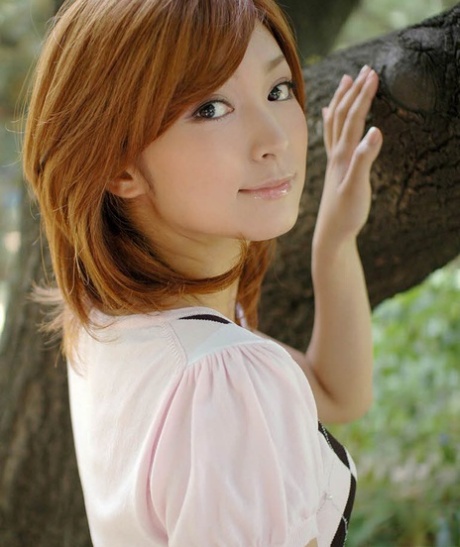 Young Japanese girl with red hair shows her upskirt underwear