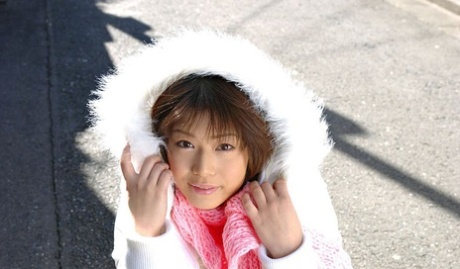 Japanese MILF Mai Haruna undoes her winter coat while wearing a bra and thong
