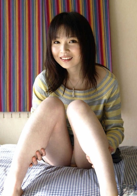 Young Japanese girl Kanan Kawaii flashes upskirt panties before getting naked