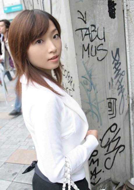 Young Japanese girl Koto sits on a toilet seat after undressing